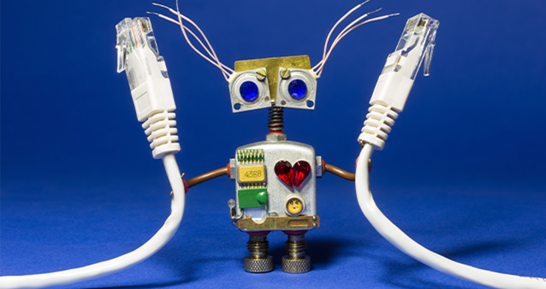 A little robot holding two network cables