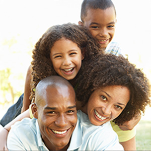 Family of 4 huddled laughing Family of 4 huddled laughing