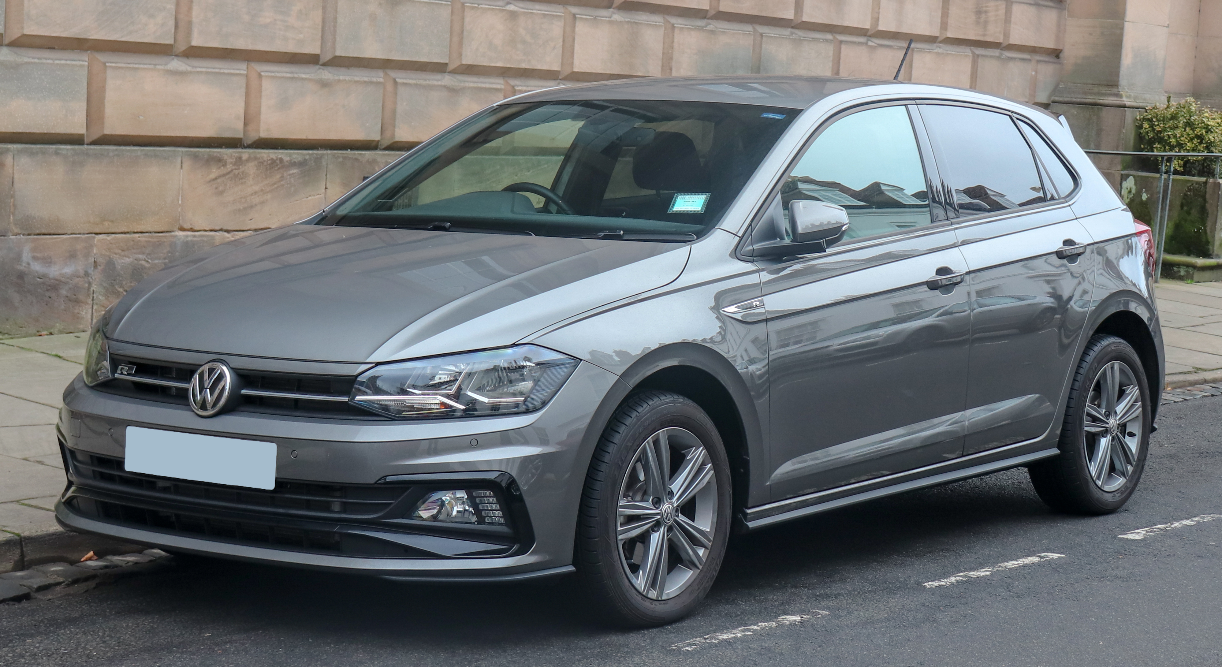 silver vw polo parked on street. symbol of success for young gauteng professionals. 