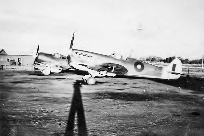 A vintage photo of a WAAF mechanic working on a Spitfire, a testament to the courage and sacrifices made during World War II, and the importance of life insurance 