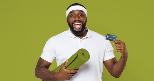 Man holding yoga mat and membership card, depicting wellness benefits of medical aid programs