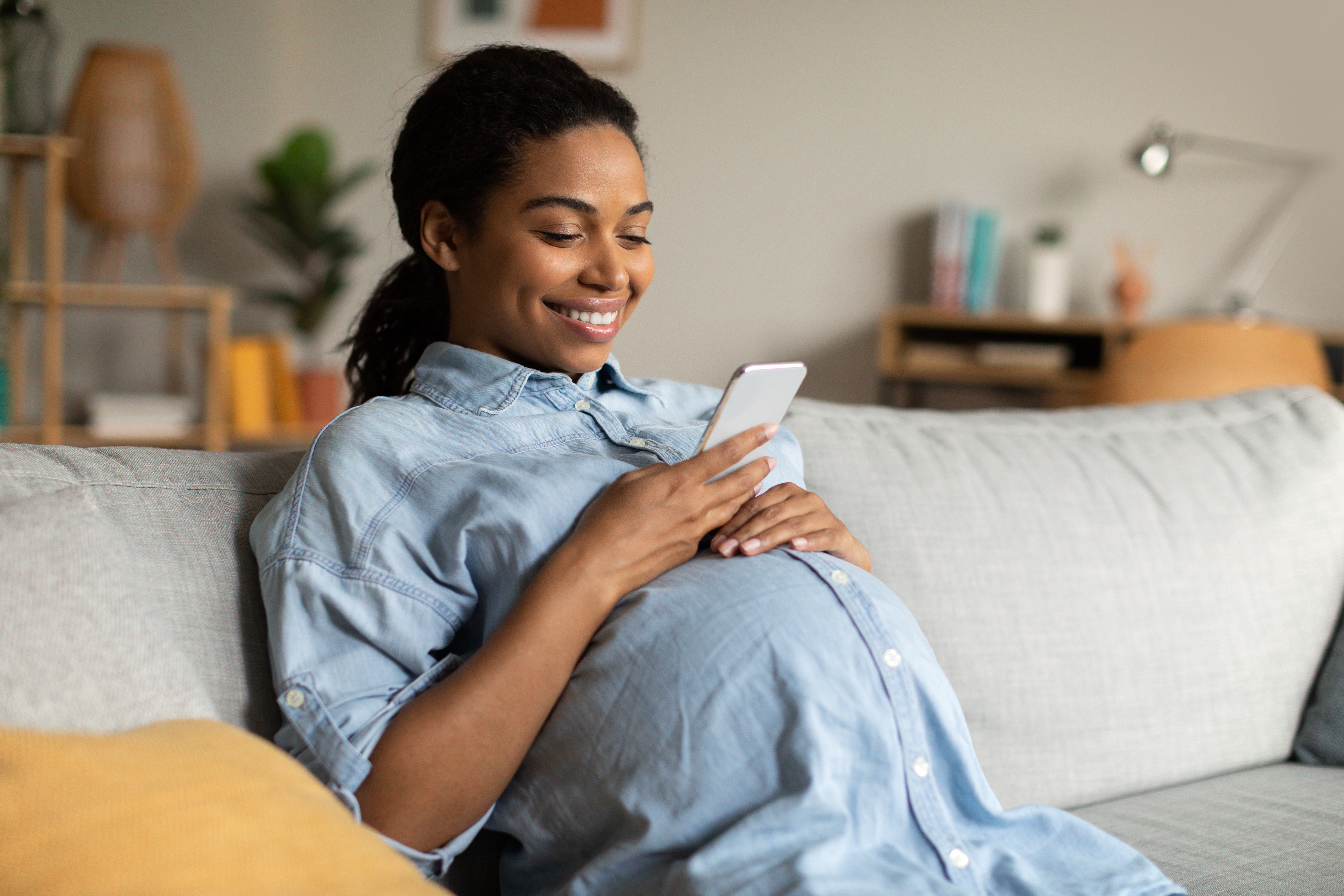 pregnant woman managing medical aid information online 