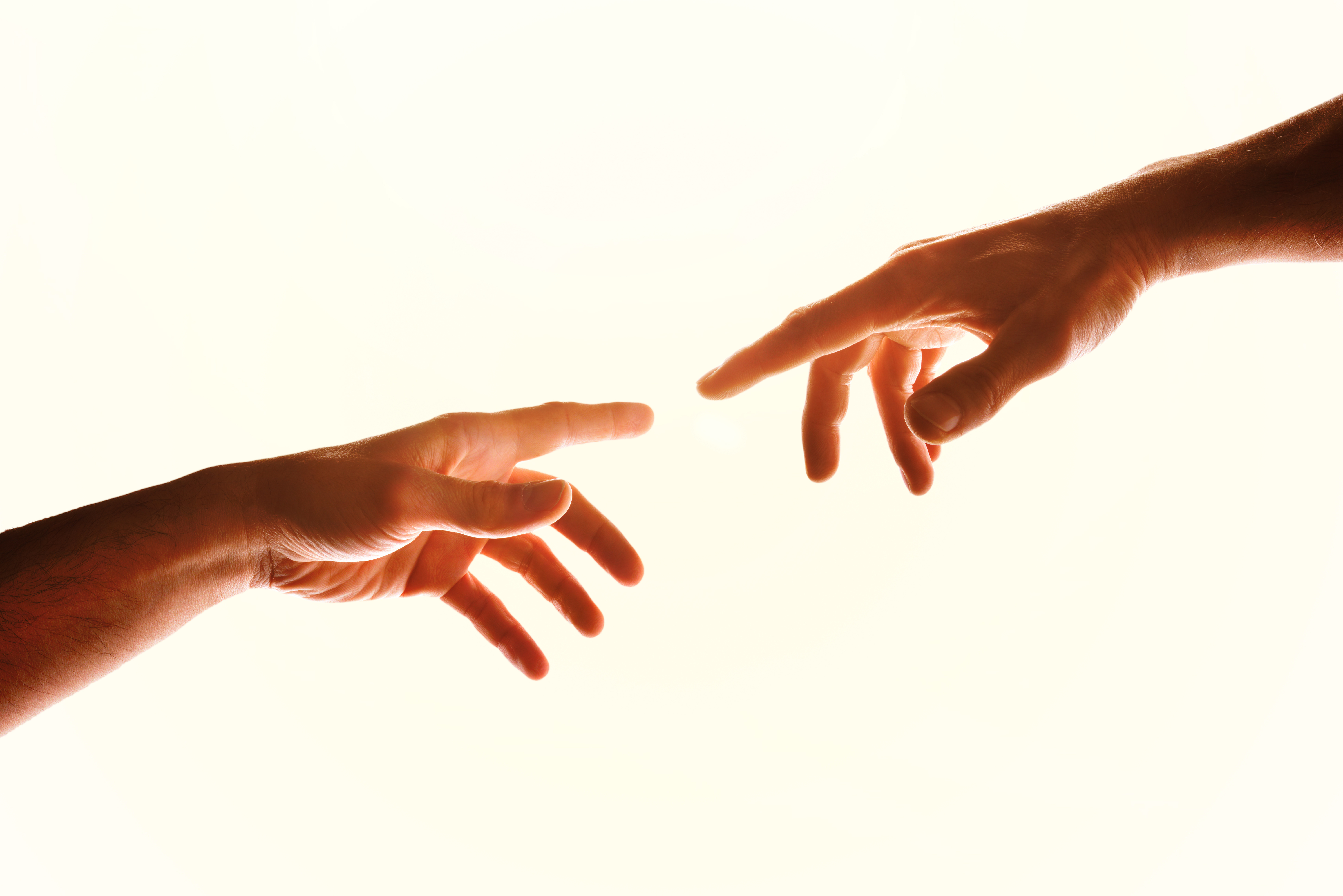 Two friends pointing index fingers at each other, illustrating the connection between gap cover and medical aid protection