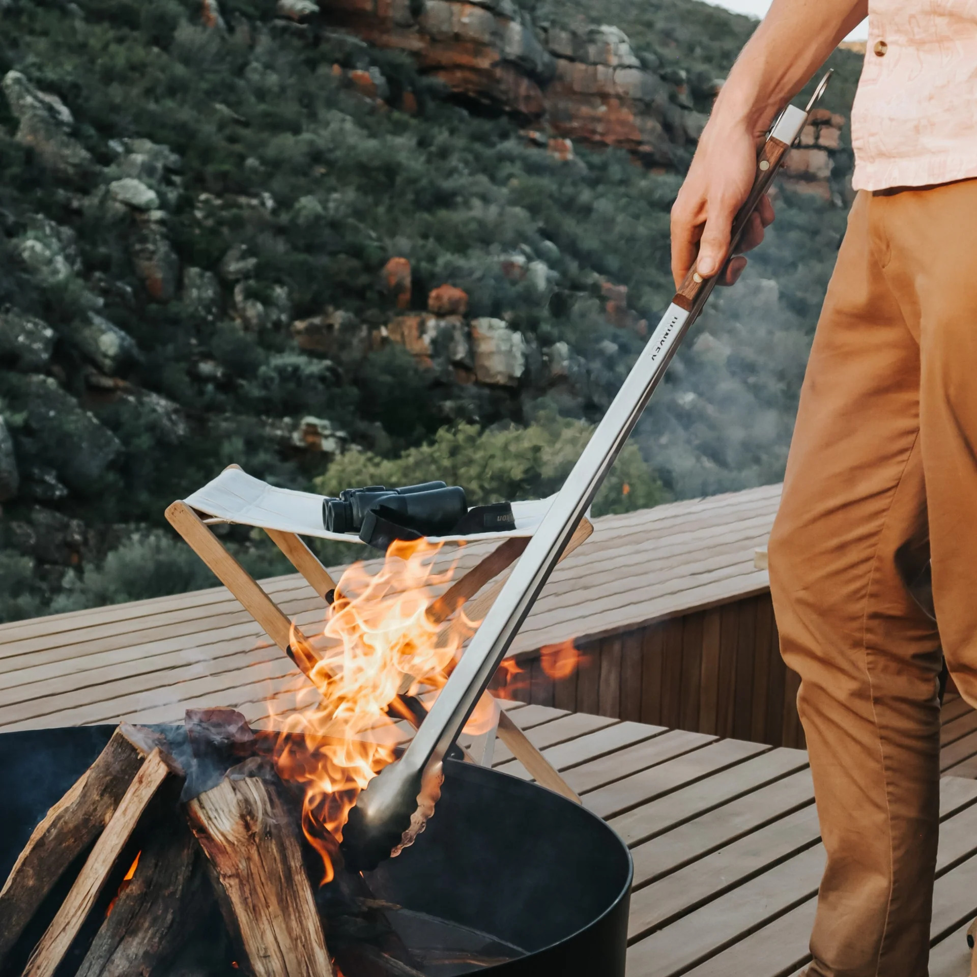 Essential braai accessories including long tongs and apron