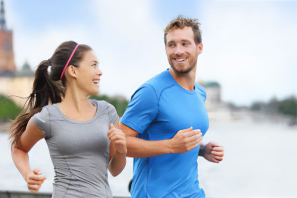 Couple jogging together smiling 